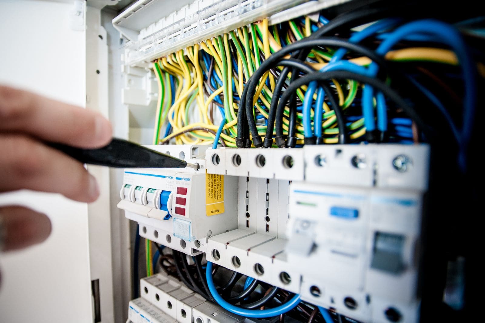 Close-up of an opened consumer unit with circuit breakers and wiring