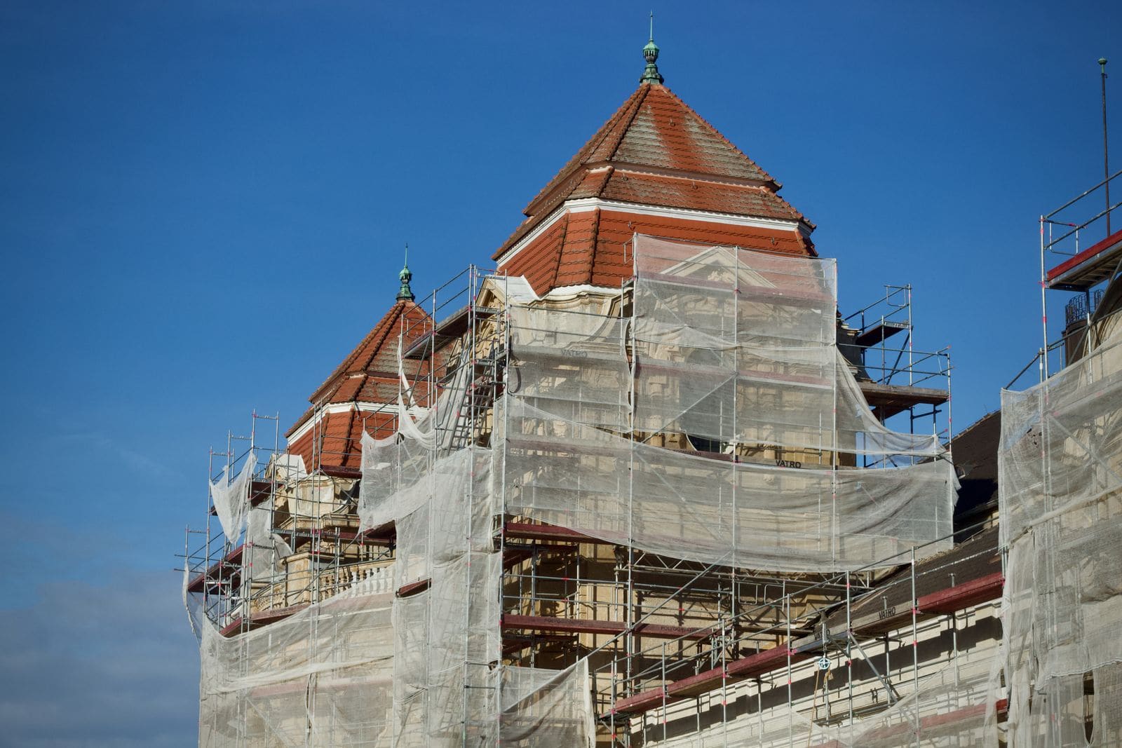 Historic building in scaffolding with safety netting during facade repair